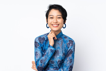 Young Vietnamese woman with short hair wearing a traditional dress over isolated white background