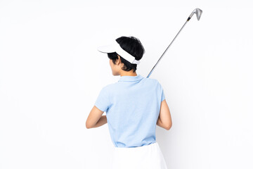 Young Vietnamese golfer woman over isolated white wall playing golf