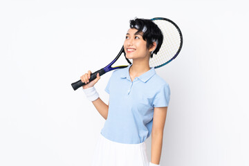 Young Vietnamese tennis player woman over isolated white wall playing tennis and looking up