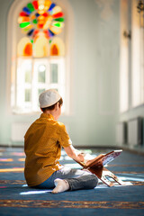 little boy in the mosque read the Quran