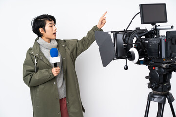 Reporter Vietnamese woman holding a microphone and reporting news pointing away