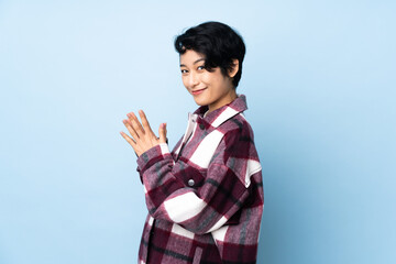 Young Vietnamese woman with short hair over isolated background scheming something