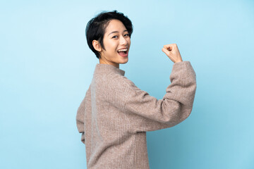 Young Vietnamese woman with short hair over isolated background doing strong gesture