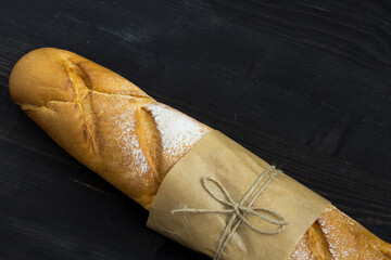 Baguette. Fresh golden baguette on an old wooden table. French traditional bread. Top view. Copy space. - 448643624