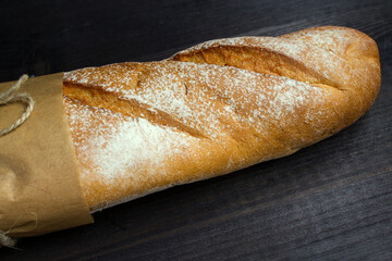 Baguette. Fresh golden baguette on an old wooden table. French traditional bread. Top view. Copy space. - 448643630