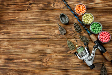 Accessories for carp fishing and fishing baits on wooden planks with copy space