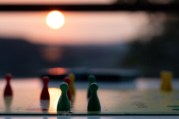 close up view of a board game with colorful game pieces -  focus on one game piece with reduced...