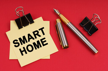 On a red background, a pen and stickers with the inscription - Smart Home