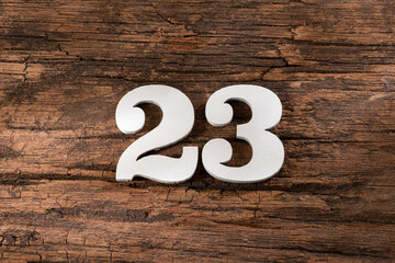 Number twenty three 23 - White Piece on Rustic Wood Background - obrazy, fototapety, plakaty