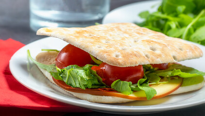 Thin slice cheese and salad sandwich on a plate
