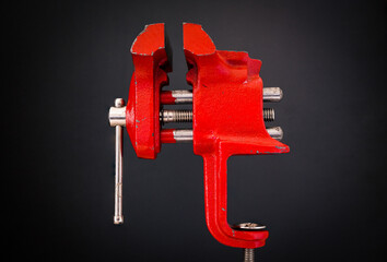 Red vice on black background