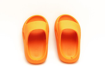 Cute pair of orange pillow slide sandals for toddler non-slip foam slippers isolated on white