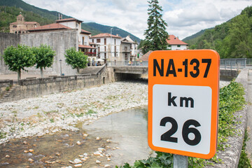 Photograph of a typical landscape of Navarra, Spain with a Roman-style bridge in a natural and mountain environment