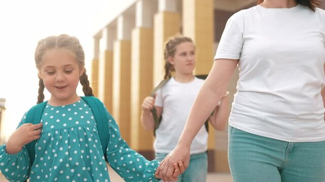 back to school. lifestyle mom and daughter a go hand in hand to school for lesson. education training support concept. child walk to school with a backpack. daughter mom rush to school. family day