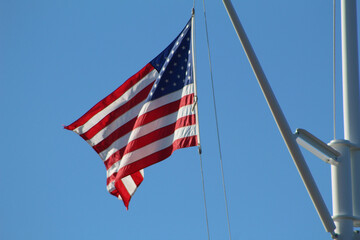 american flag against blue sky