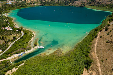 Aerial view of a huge freshwater lake surrounded by tall mountains (Lake Kournas, Crete, Greece)
