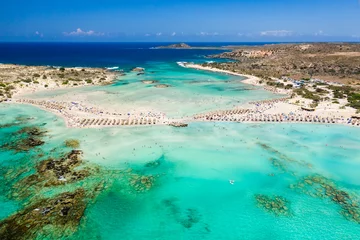 Foto op Plexiglas Elafonissi Strand, Kreta, Griekenland Aerial view of a beautiful but busy sandy beach and shallow lagoons surrounded by clear, blue ocean (Elafonissi, Crete)