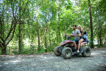 young Couple ride ATV, traverse forest with joy and excitement,adventure travel