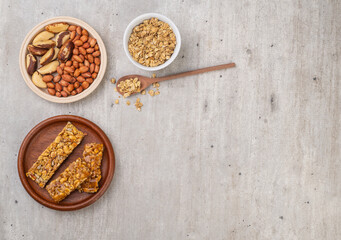 Homemade cereal bars with nuts, muesli and copy space