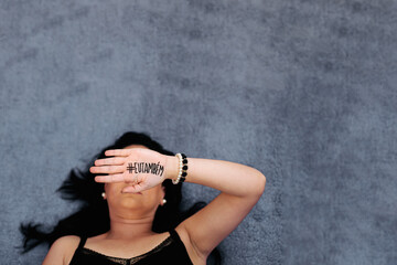 woman on pink background with palm of hand written # me too
