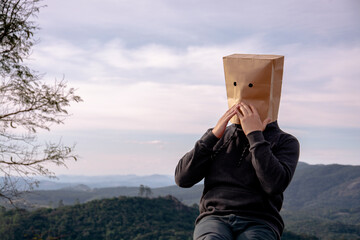 man with paper bag on his head outdoors