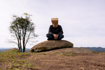 man with paper bag on his head outdoors