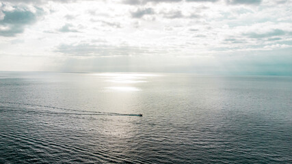 boat on the sea during a sunset aerial view