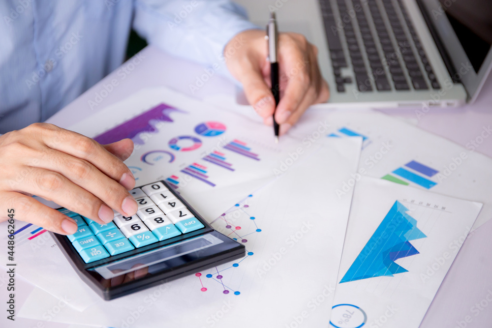 Aufkleber hands of businessman calculate tax with calculator while laptop computer on desk, man planning finan