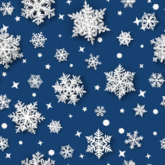 Christmas seamless pattern of paper snowflakes with soft shadows, white on blue background