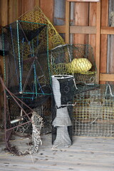 Crab pots stacked in a fisherman's shed with old fashion gillnet hanging bench