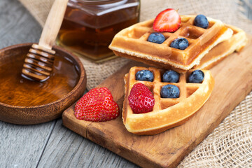 homemade waffles with berries and honey