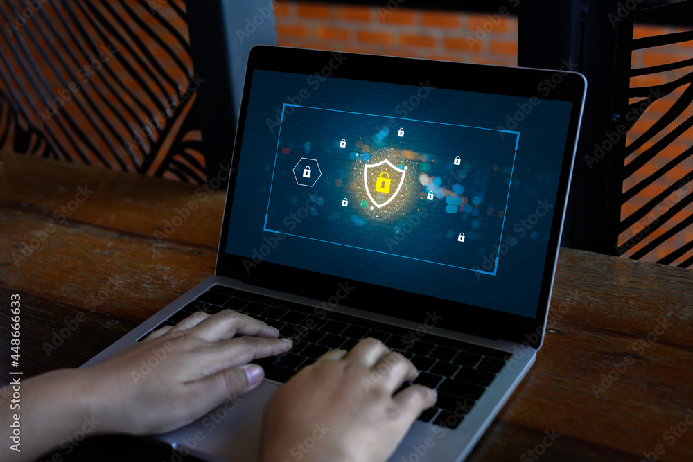 Poster person using a laptop computer with data protection, cyber security, information safety and encrypti