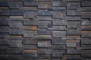 Gradient light on surface of gray stone slate wall background in vintage tone style