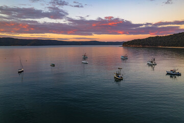 Fototapeta premium Peaceful sunrise over the bay with boats