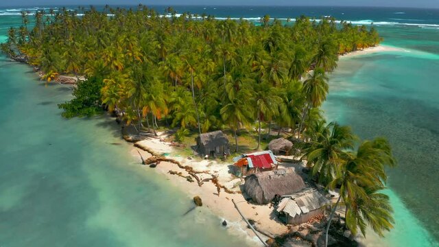 Indigenous People's Hut At Tropical Island With Coconut Trees At San Blas Islands In Panama. - aerial