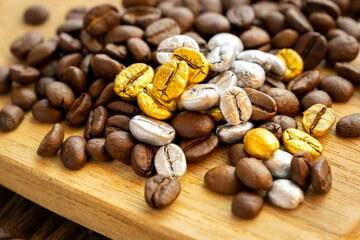 Luxurious silver and gold premium coffee beans on a heap of beans.