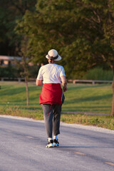 senior person walking on the road