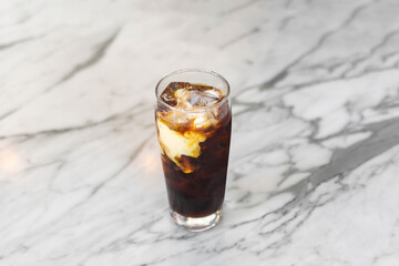 Coffee latte in glass cup on marble table 