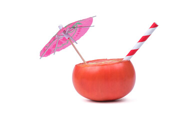 Umbrella and cocktail tube in an isolated tomato on a white background.