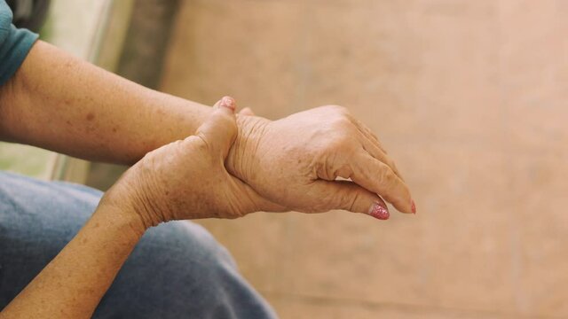 Seniors hands with feeling pain for her hands and arms which might be the elderly diseases such as guillain�barre syndrome and rheumatoid occurring due to nervous system and muscle weakness.