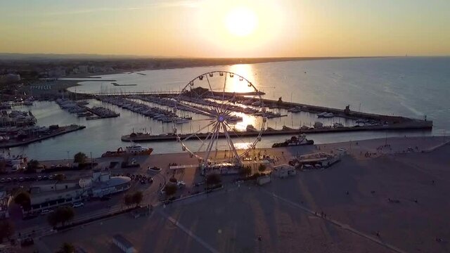 Scenic View Of Ferris Wheel Near Shoreline Beach Of Rimini, Italy At Sunset. - Aerial Shot