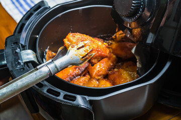 Frying BBQ chicken wings in a hot air fryer.