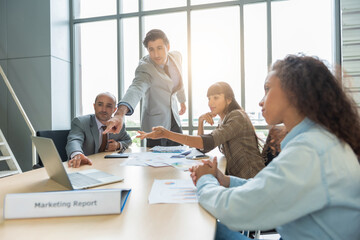 Group of men and women having casual discussion during meeting sitting in office.