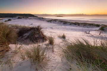 early morning light from the sand dunes on beach