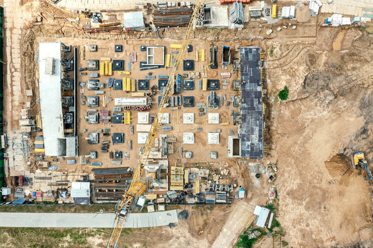 multilevel parking garage under construction. building the foundations on the construction site with a yellow crane. aerial top view