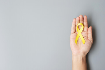 Childhood Cancer, Sarcoma, bone, bladder and Suicide prevention Awareness month, Gold Yellow Ribbon for supporting people living and illness. children Healthcare and World cancer day concept - obrazy, fototapety, plakaty