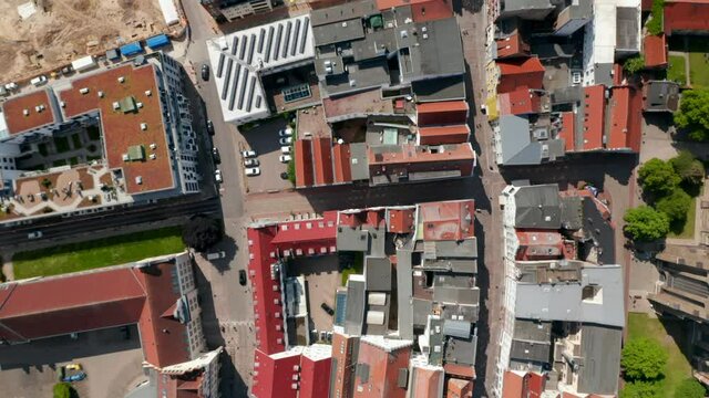 Aerial birds eye overhead top down view of buildings in city centre. Mixture of classical and modern houses. Fly above Kropeliner street