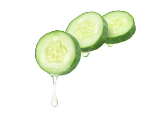 Cucumber essential oil dripping from cucumber slices isolated on white background.