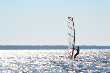Windsurfing. Fun in the sea. Extreme Sport. Woman lifestyle. Summer vacation.