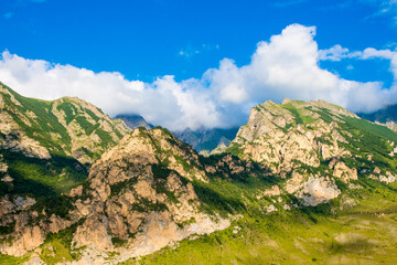 Rocky mountains and clouds above them. Mountains on a summer day. Caucasus Mountains, Kabardino-Balkaria
